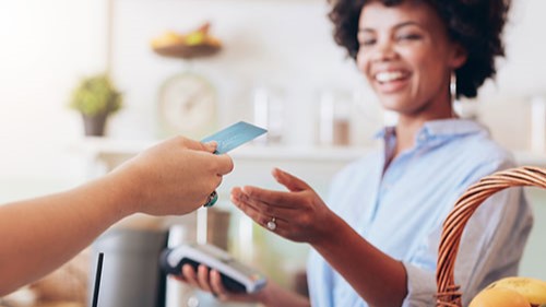 Woman checking out at a cafe.