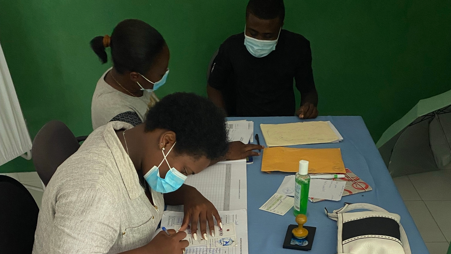 Haiti-Earthquake-Response-2 womens filling out forms at covid 19 testing site