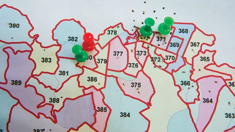 Map with Pins Map with numbered areas marked by green and red push pins indicating specific locations.