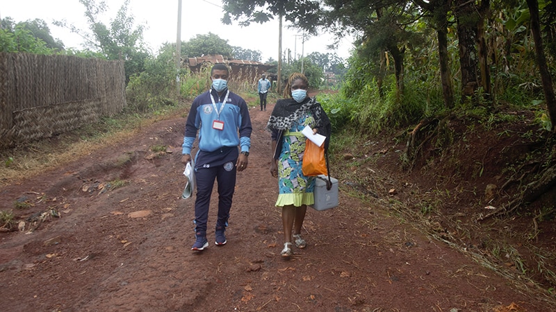 CDC supports Cameroon to ensure delivery of quality HIV/TB during COVID-19_003 two individuals walking from HIV testing site