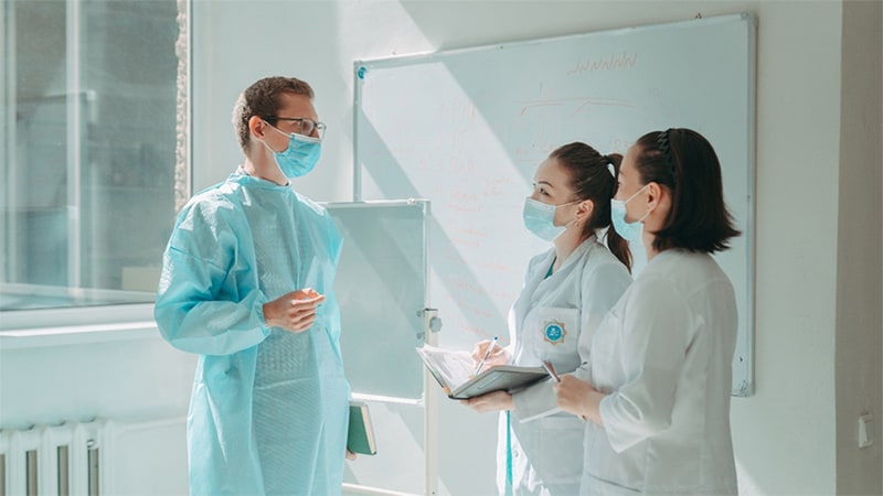 Photo of 3 laboratorians talking.