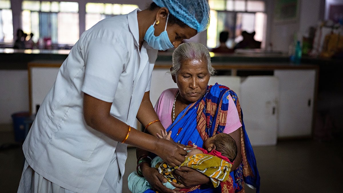 Hep B birth dose vaccination in India A woman in India holds her grandchild as a health worker gives the baby a hepatitis B birth dose.