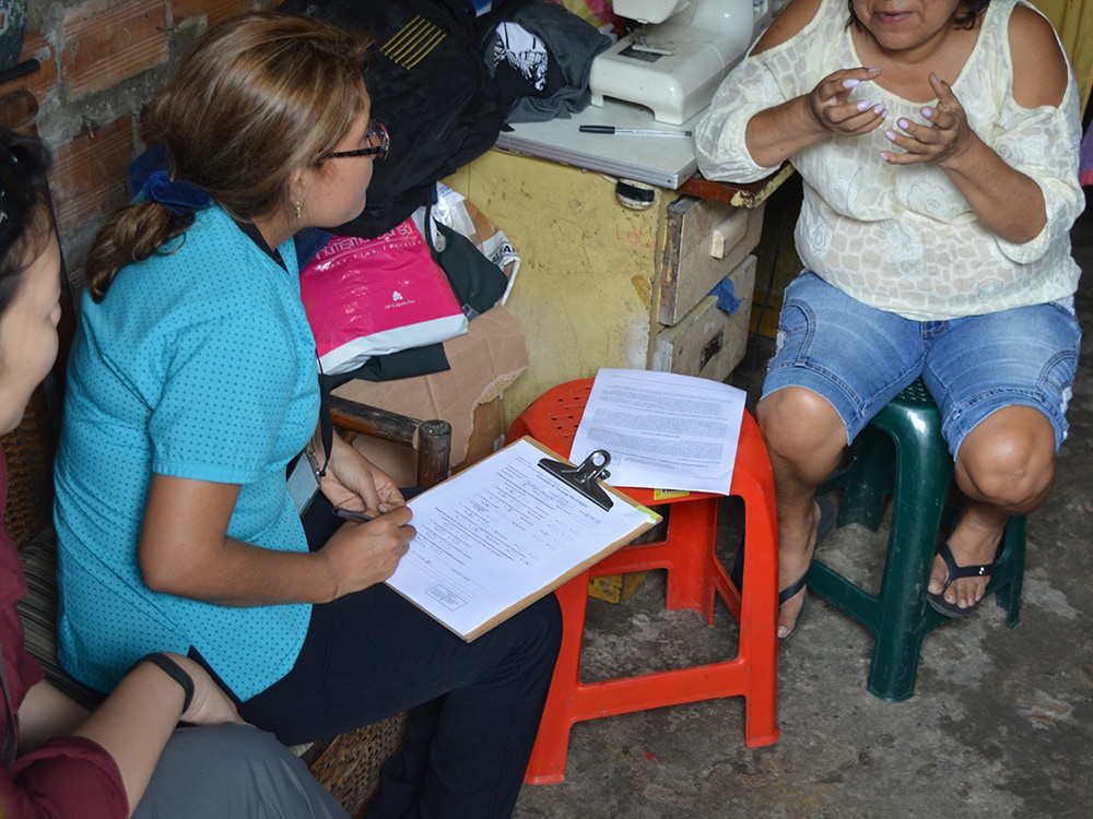 Study staff administering neurologic symptom screening questionnaire as part of Zika study in Iquitos, Peru. Photo: Wes Campbell, Walter Reed (Formerly NAMRU-6)