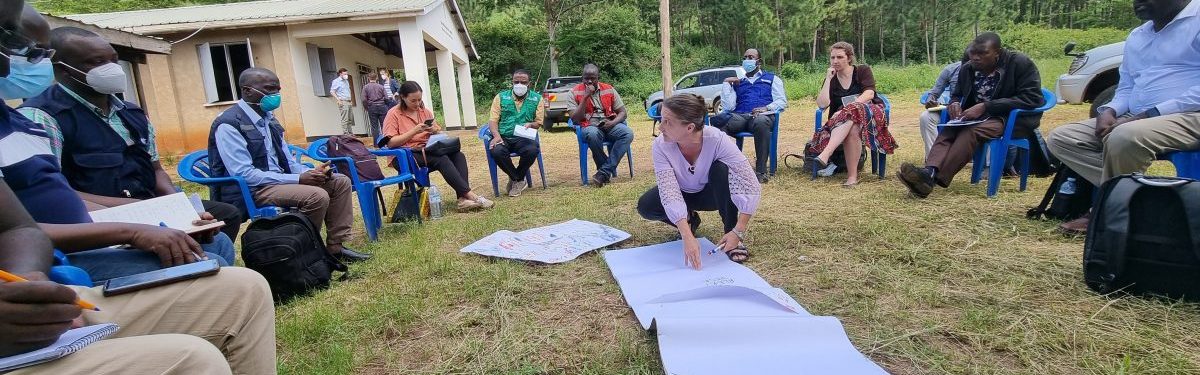 DGHP Banner CDC Director and participants outside in Uganda organizing surveillance activities during the Ebola response.