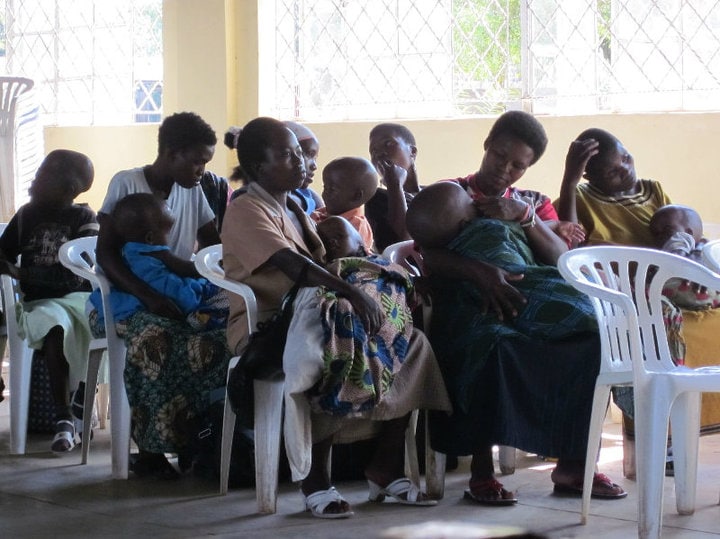 group of mothers holding their babies