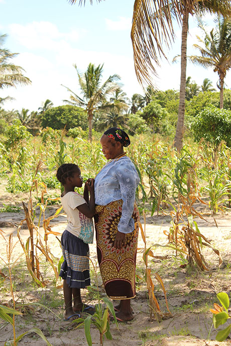 mother and daughter stand in a field