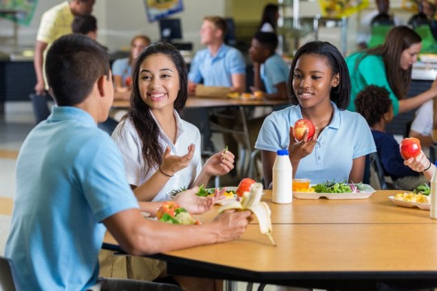 GettyImages-641510086_lg Diverse teenage friends eat lunch in school cafeteria