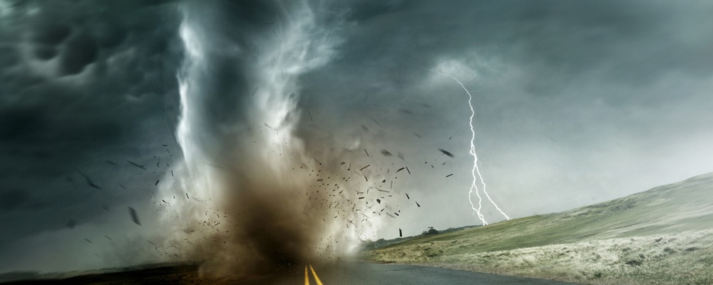 Extreme weather Image of a large tornado during touch down on an empty long road.