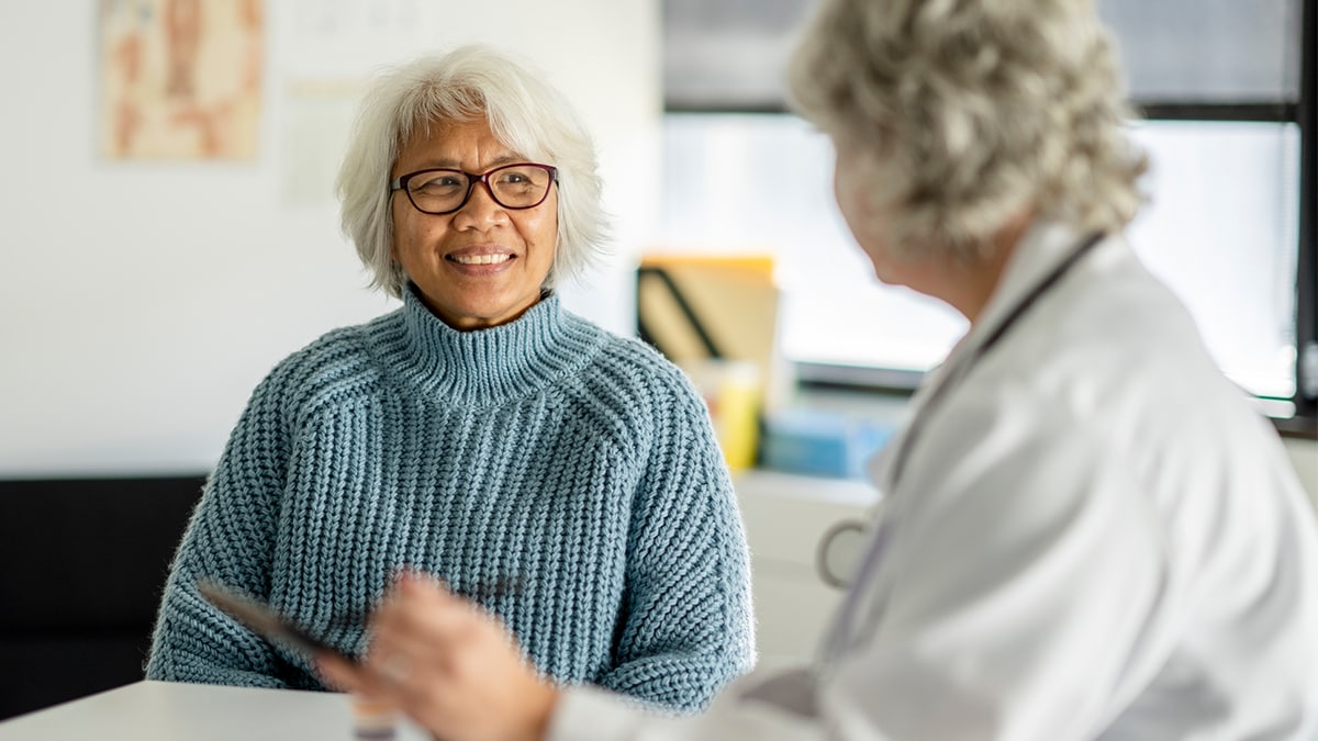 A healthcare professional meets with a patient to discuss hepatitis a and b testing and vaccination resources