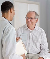 doctor with seated elderly man