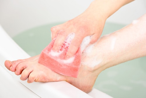 Person washing their foot