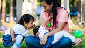 breastfeeding in a park A mother breastfeeding in a park.
