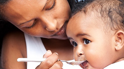 Spoon feeding A mother spoon feeding her child