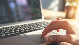 hand using a laptop touchpad