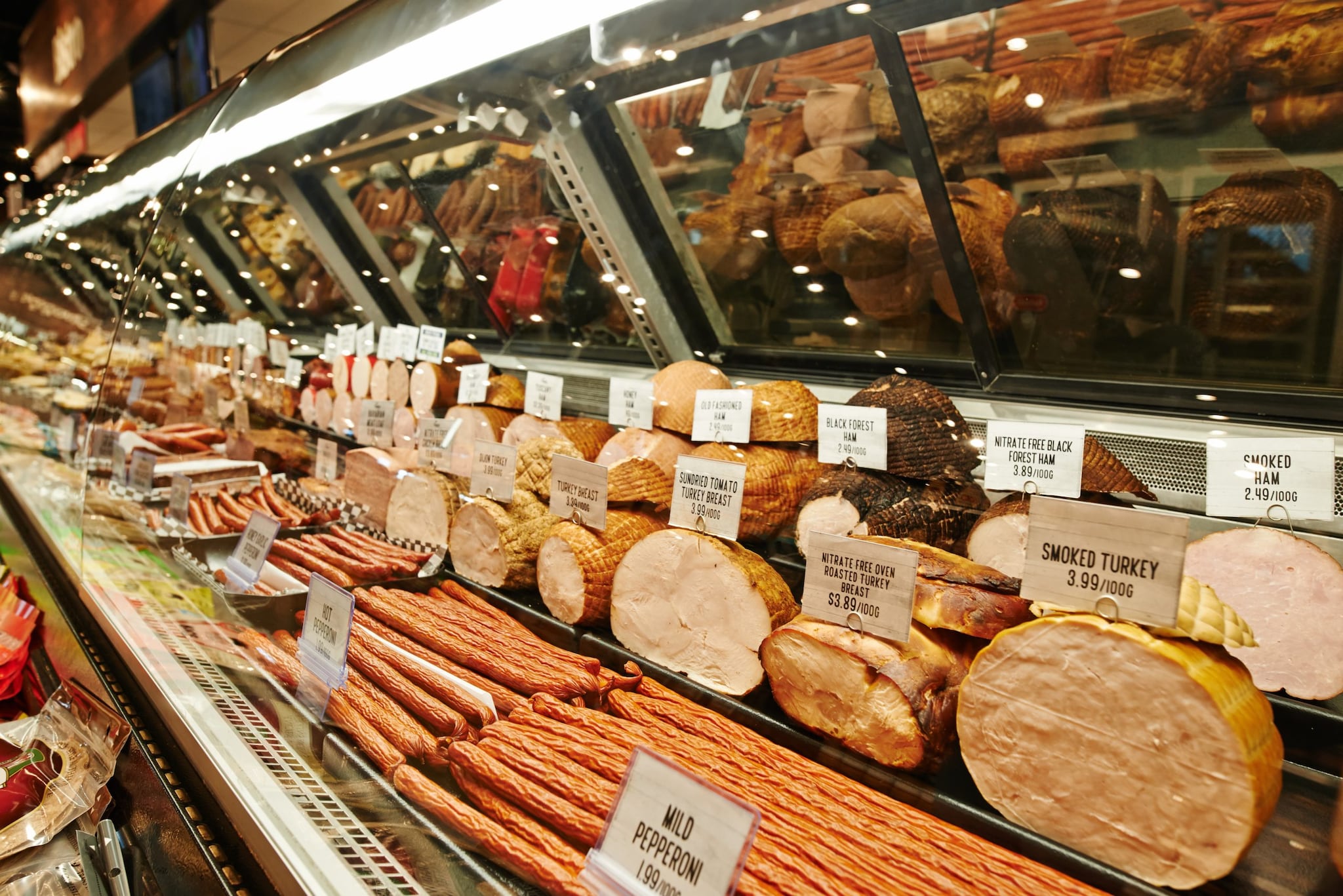 Deli Meat A deli market depicting different types of deli meat on display for slicing.