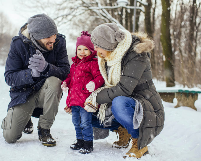 p1119-8-holiday-tips-cold-weather-safety father and mother with toddler in the snow