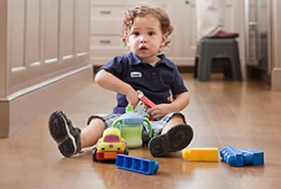A little boy playing with toys on the floor