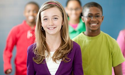 preteens-school Preteen children walk through a hallway at school.