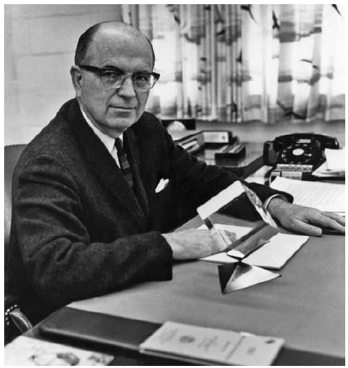 The figure is a photo of Alexander Langmuir at his desk in 1966