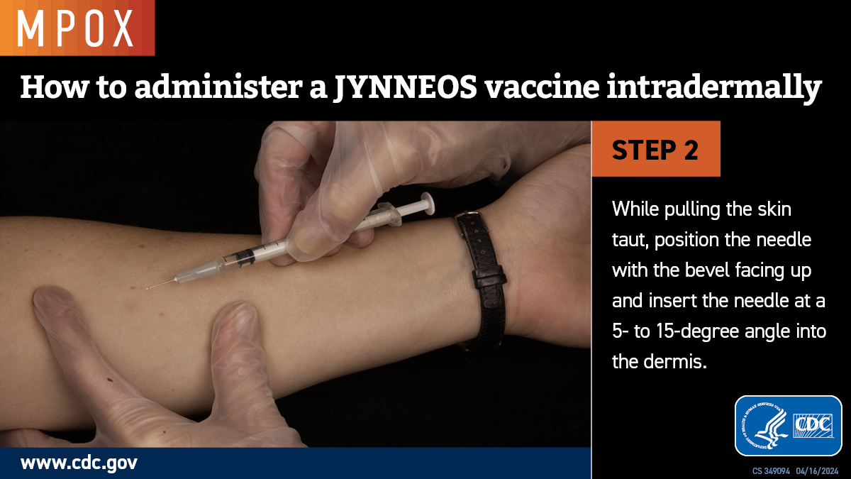 A photo of a gloved hand inserting a needle into a forearm.