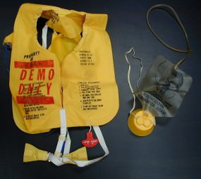 1980 This bright yellow life vest and oxygen mask are souvenirs from the “Red Spots” Epi-Aid.