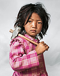nepal-child.jpg Photograph of a Nepalese child holding a hammer