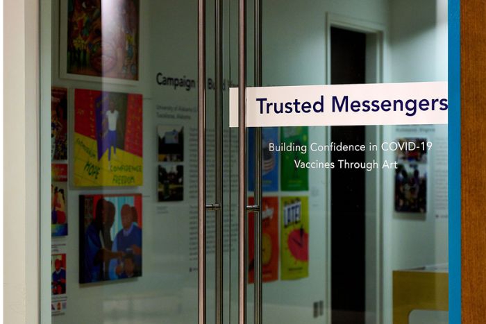 Trusted Messengers Glass door with Trusted Messengers sign