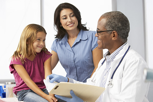 doctor-consultation Doctor examining young girl with mother present