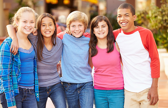group-of-pre-teen-friends A group of pre-teen friends with their arms around each other