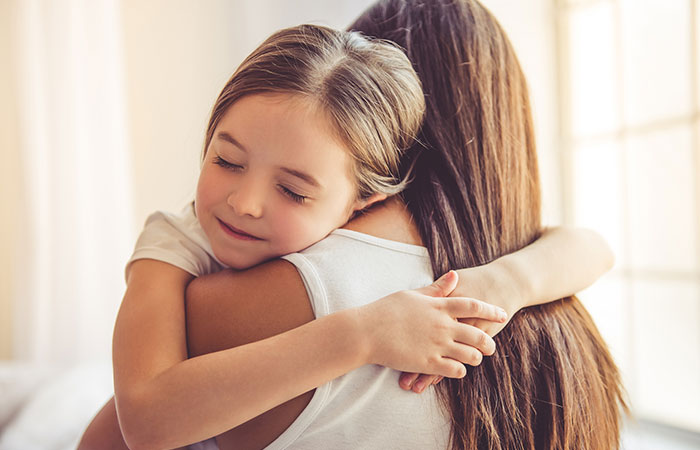 Mother hugging daughter
