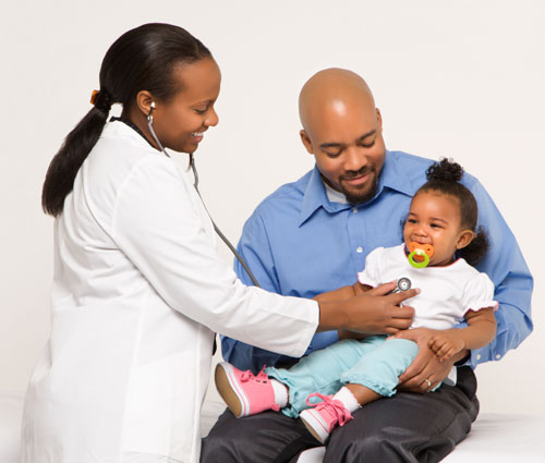 father-daughter-doctor-visit500px.jpg A father holding his daughter at her doctor visit