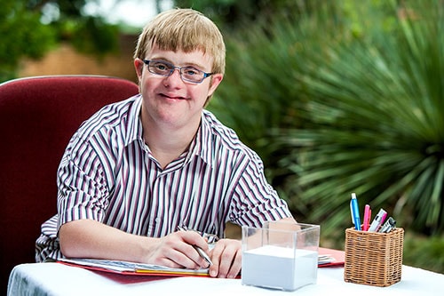disabled-man-at-desk.jpg A disabled man working at his desk.