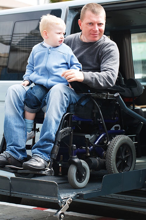 Disabled Men with son on Wheelchair Disabled Men with son on Wheelchair
