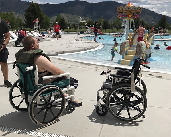Man in a wheelchair by the pool Man in a wheelchair by the pool