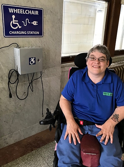 Woman charging her wheelchair Woman charging her wheelchair