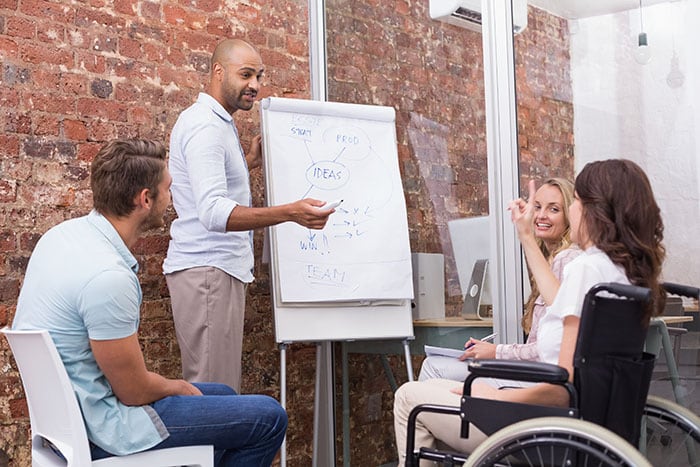 Businessman making a presentation to his fellow coworkers Businessman making a presentation to his fellow coworkers