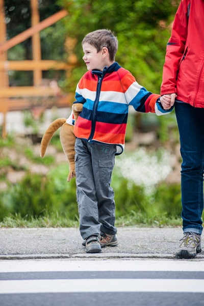 boy-holding-hands-crosswalk.jpg A boy holding his caregivers hand in the crosswalk