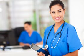Female nurse in blue uniform with tablet 