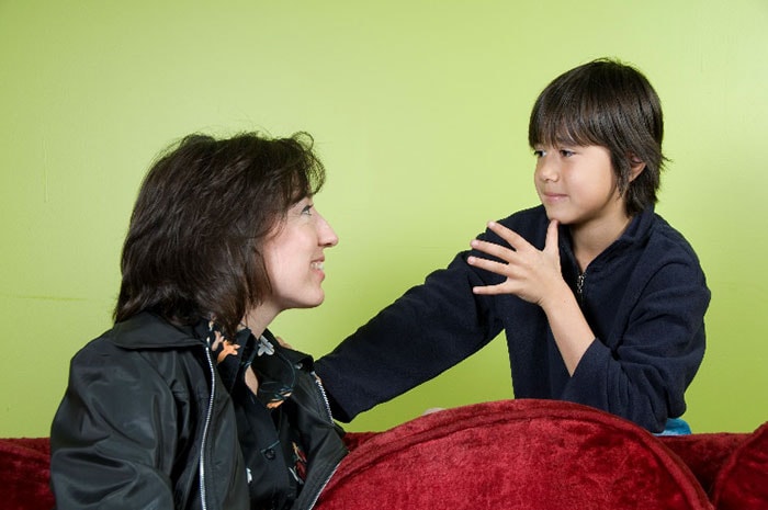 son-using-sign-language-with-mother Son using sign language with mother
