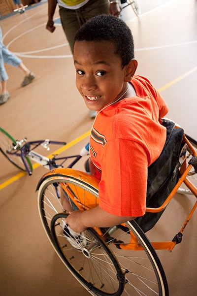 twinlakes_0524 A boy with spina bifida smiles in his wheelchair
