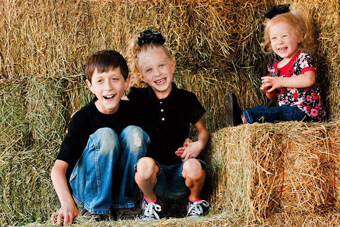 kids-haystack Kids sitting on a haystack