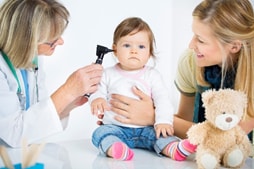 baby-exam A doctor examining a baby