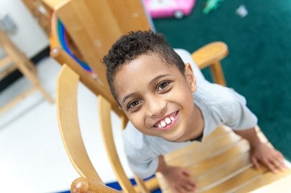 boy-laying-across-chair-looking-up Boy laying across a chair, looking up
