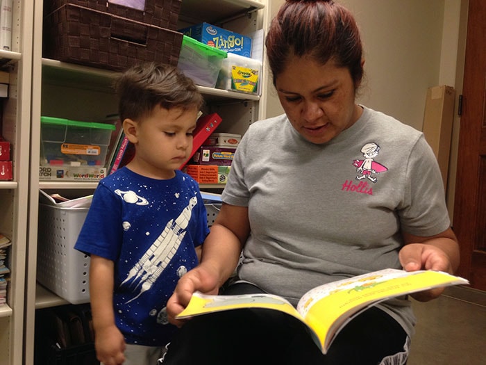 caregiver-reading-to-child A mother reading to her child