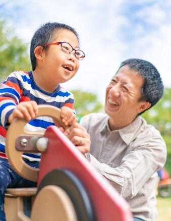 father-and-son-at-park Father and child with disability at the park