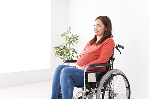 Pregnant woman ride in a wheelchair Pregnant woman ride in a wheelchair