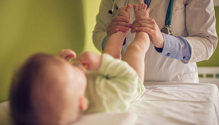 Diagnostic Tools Doctor testing a baby's reflexes