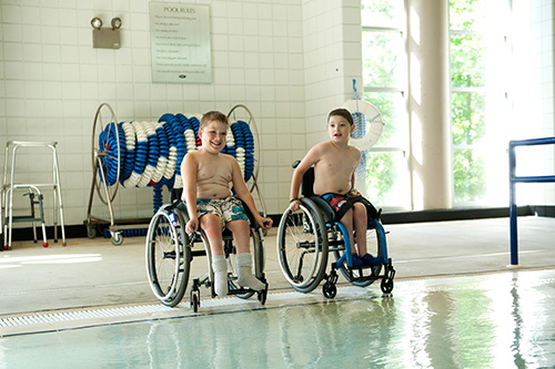 lakeshore-poolside Two boys in wheelchairs at Lakeshore Pool
