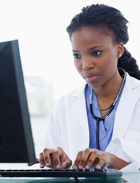 African-American woman doctor using a computer African-American woman doctor using a computer
