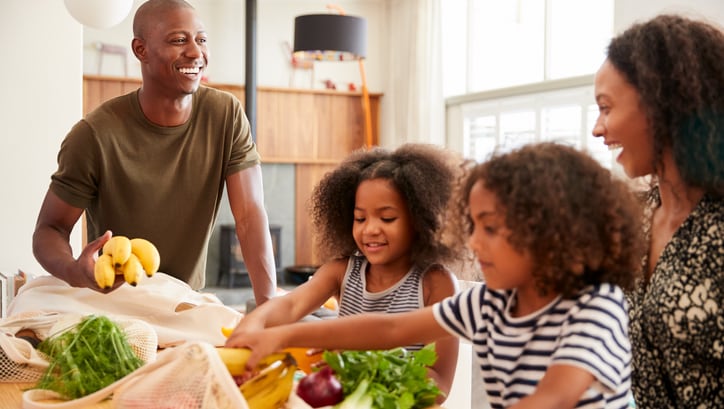 — title missing — Family handling fruits and vegetables in a kitchen